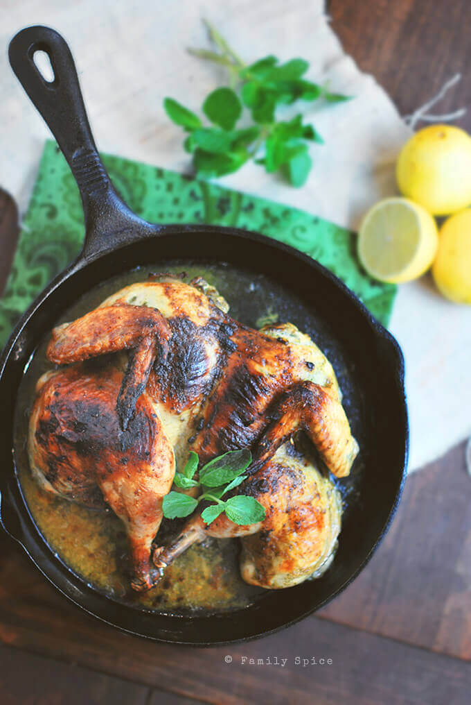 This Spatchcocked Chicken with Mint and Garlic is marinated with mint, lemon zest and garlic and roasted in a cast iron pan for a quick and easy meal for any day of the week. -- FamilySpice.com