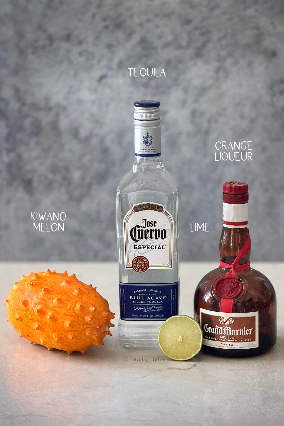 Ingredients labeled and needed to make a halloween margarita with kiwano melon.