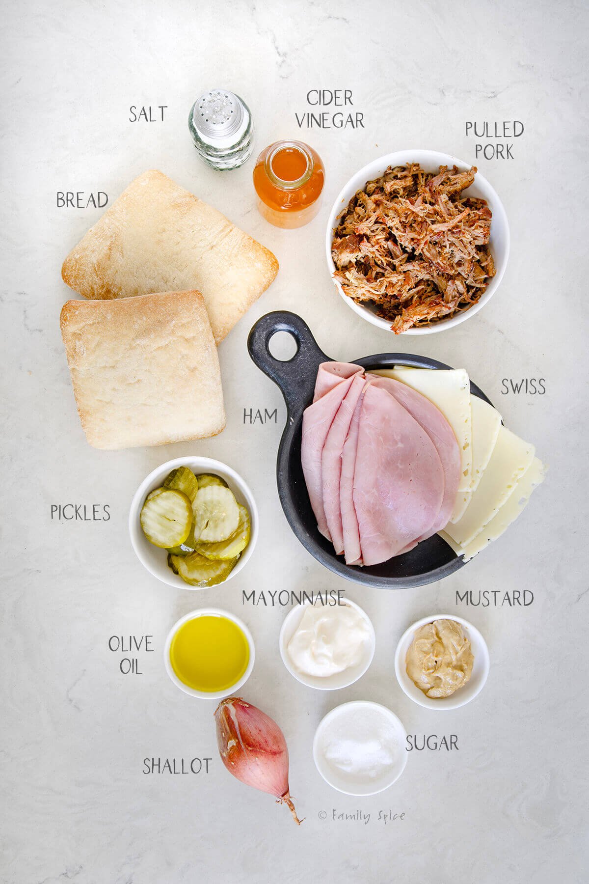 Ingredients labeled and needed to make pulled pork cubano sandwiches.