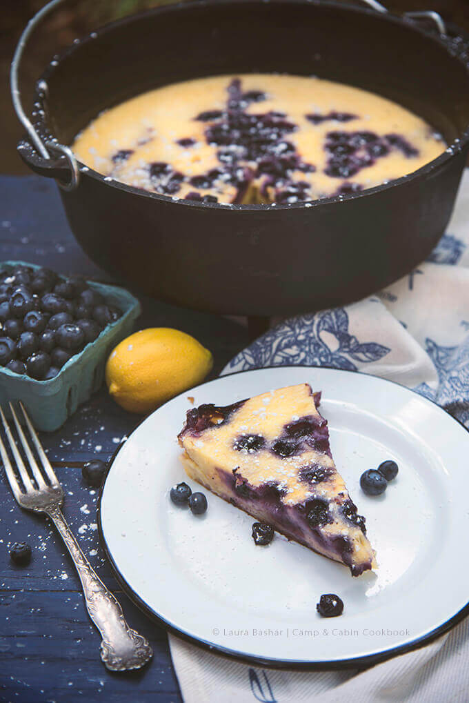 Dutch Oven Lemon Blueberry Clafoutis from The Camp & Cabin Cookbook by Laura Bashar (familyspice.com)