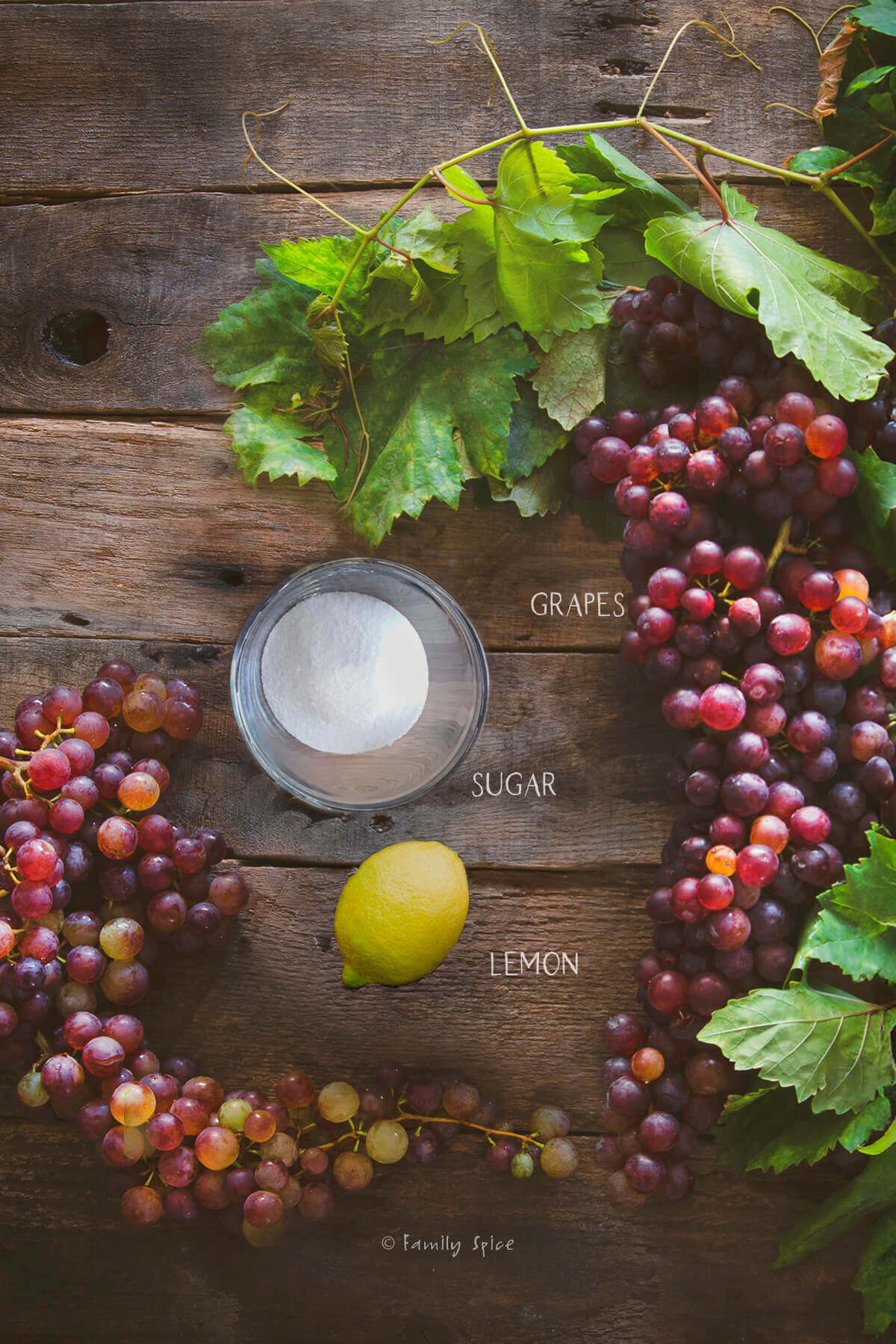 Ingredients labeled and needed to make homemade grape jam.