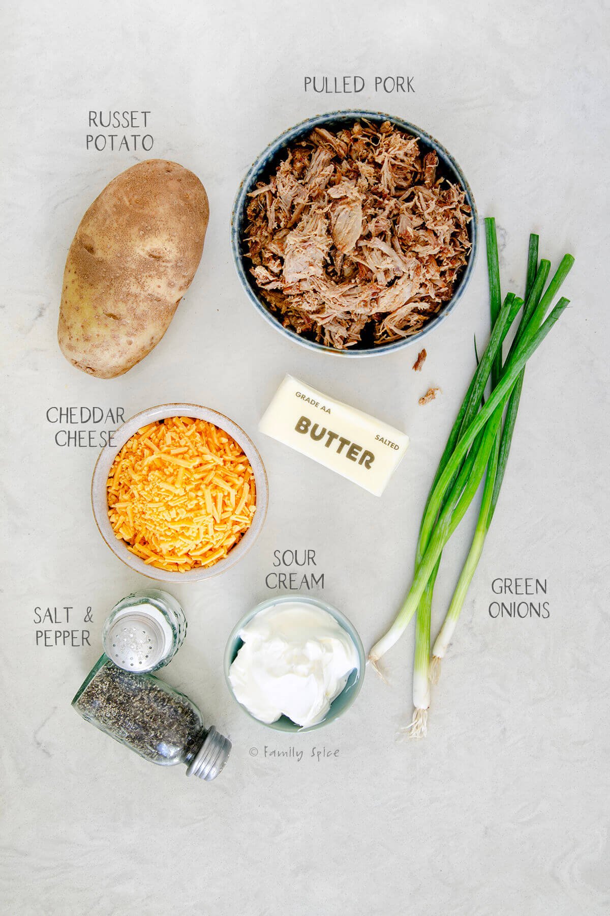 Ingredients labeled and needed to make pulled pork baked potatoes.