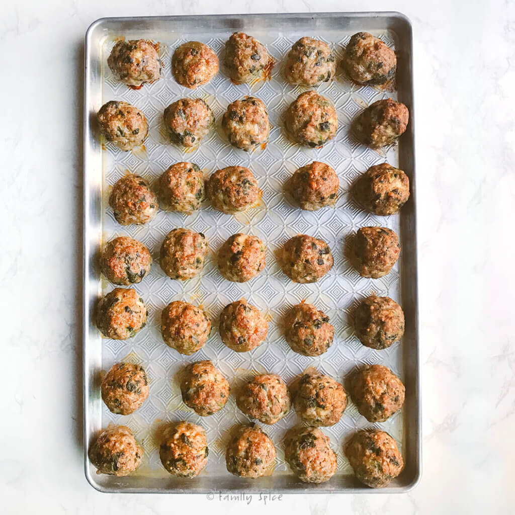 A baking sheet full of oven baked meatballs.