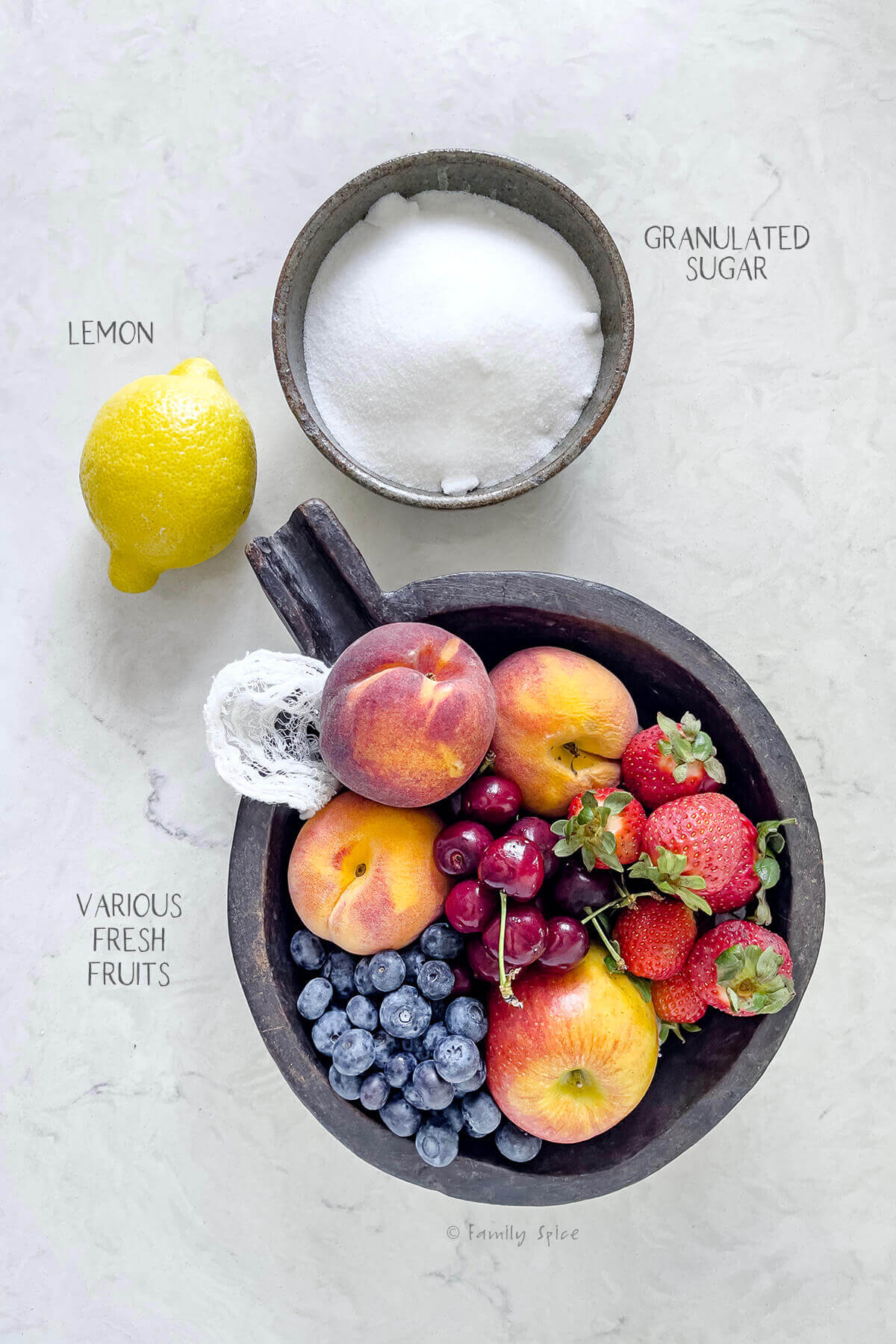 Ingredients labeled and needed to make mixed fruit jam.