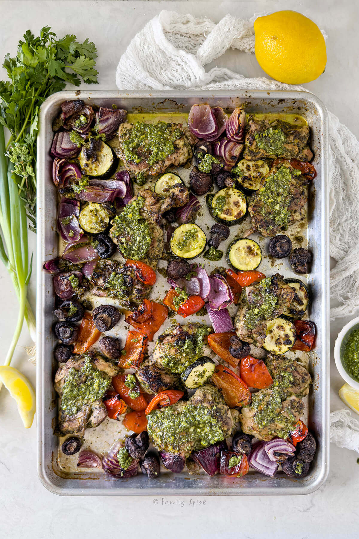 Top view of sheet pan chicken chimichurri with vegetables.