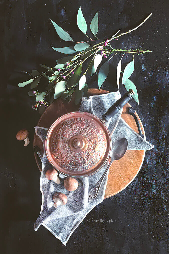 Covered copper pot with wooden tray, greens and flowers by FamilySpice.com