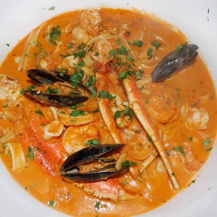 Top view of a big white bowl with Brazillian seafood stew in it
