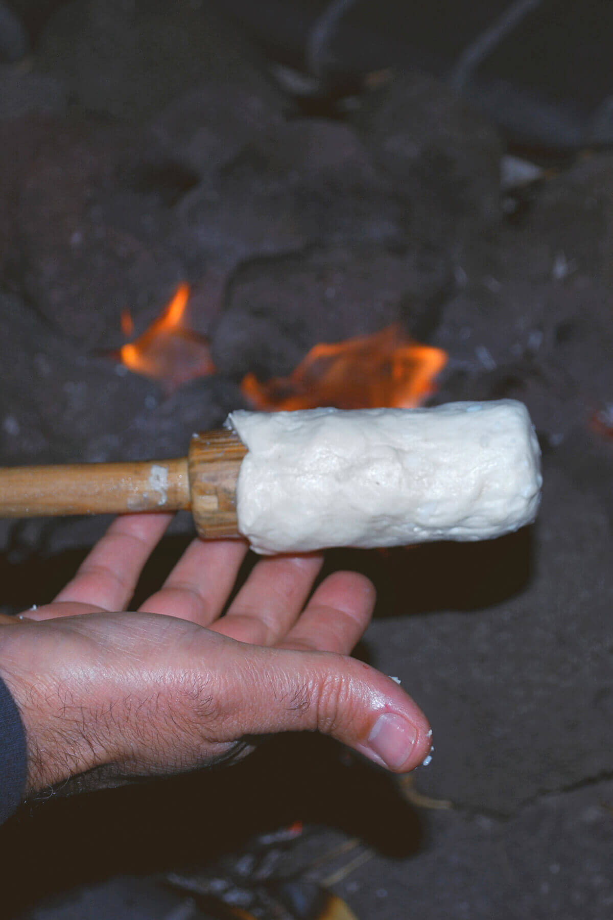 Raw biscuit down formed on a large wooden stick