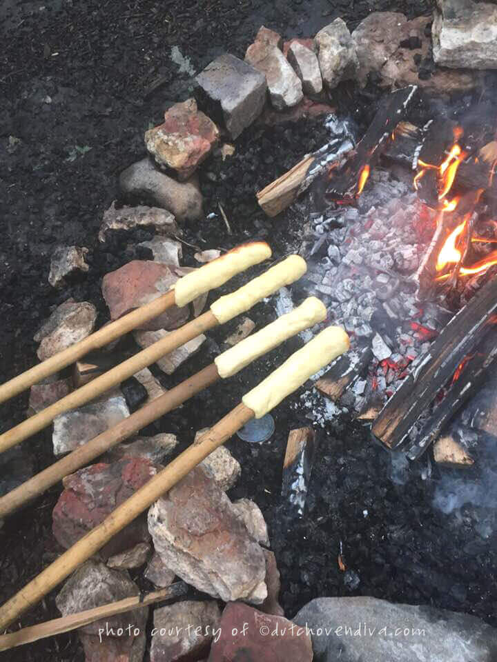 Cooking campfire eclairs over a campfire ring