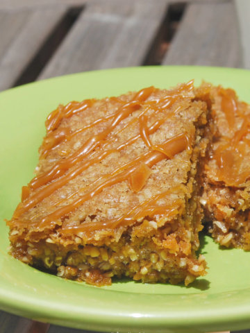 Two oatmeal butterscotch bars on a green plate