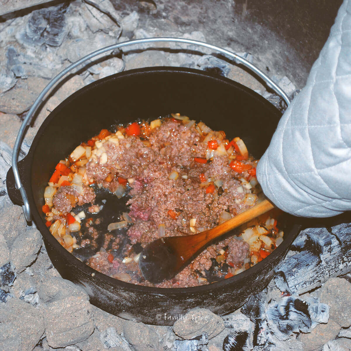 Browning ground beef with onions and peppers in a cast iron dutch oven