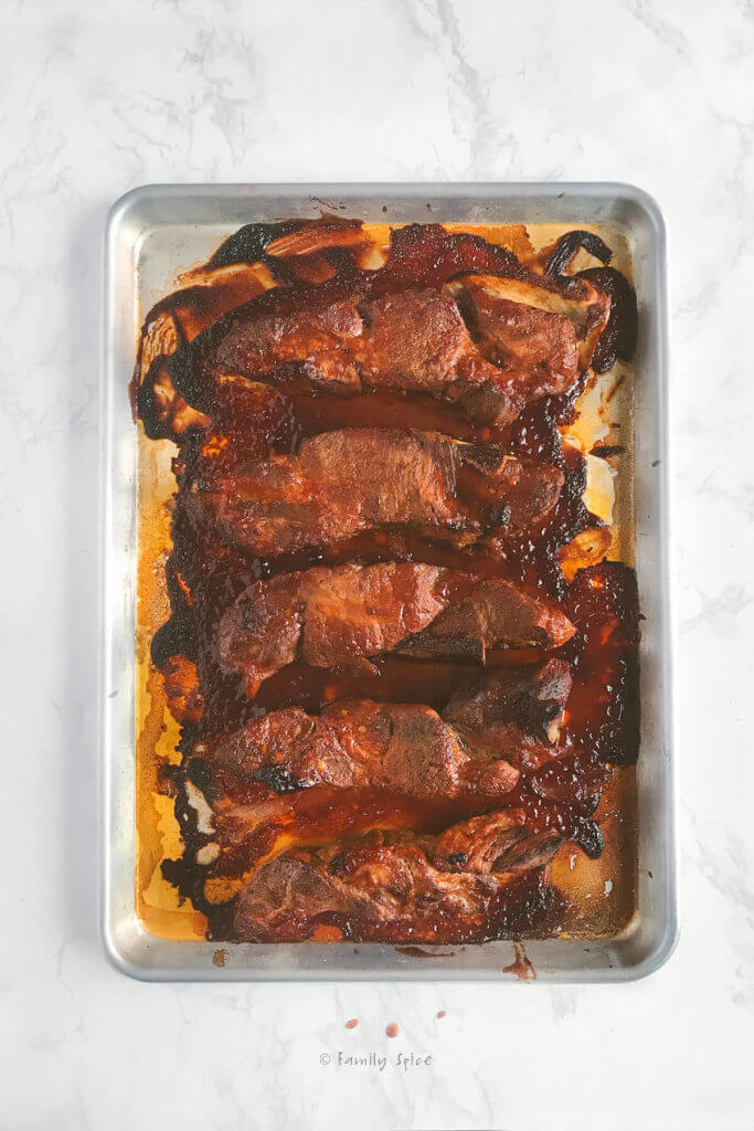 Barbecue pork country style ribs on a baking sheet freshly baked from the oven