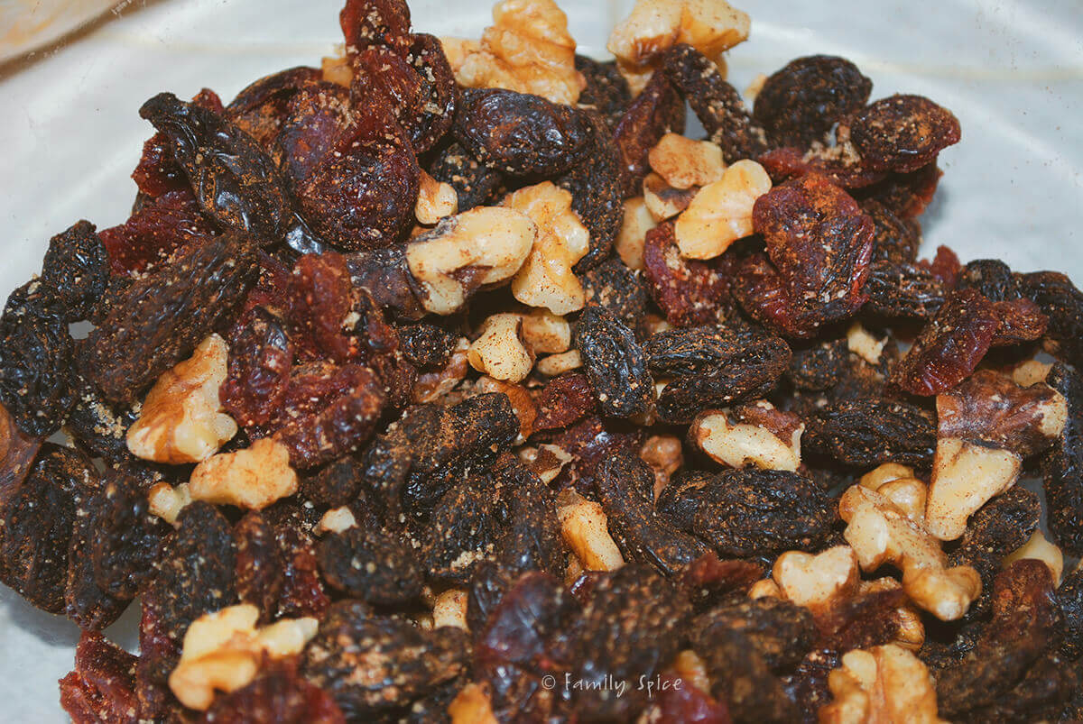 Closeup of nuts and raisins mixed with cinnamon and sugar