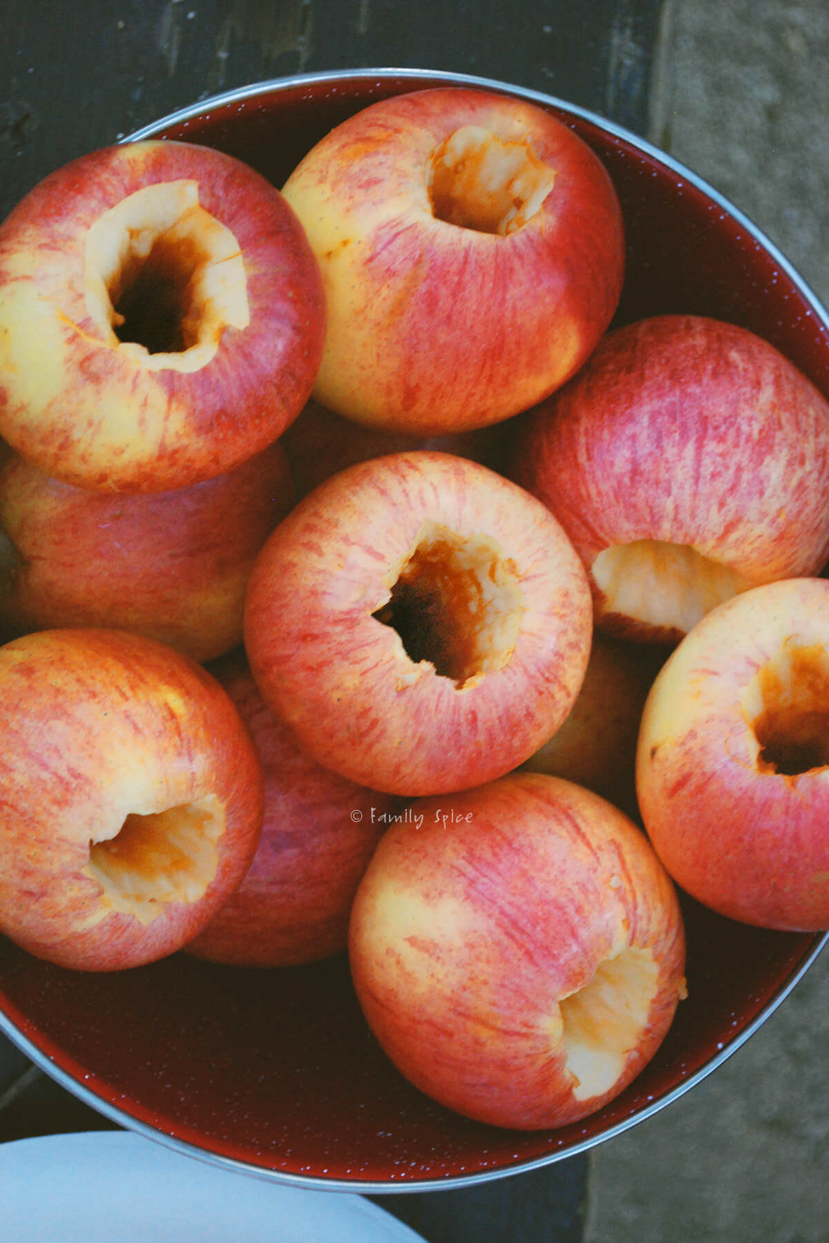A bowl of cored red apples