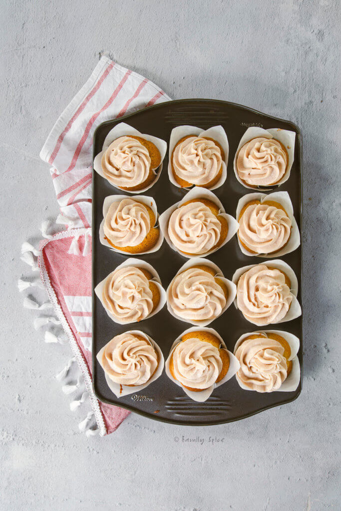 A 12-count cupcake tray with frosted Baileys cupcakes