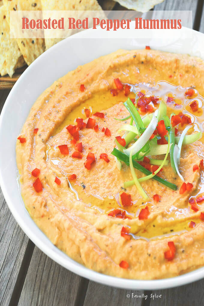 Closeup of a bowl full of roasted red pepper hummus by FamilySpice.com