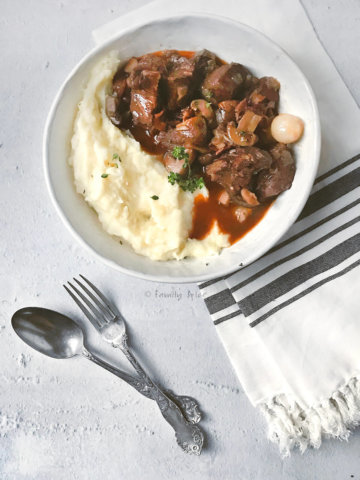 Top view of a bowl with mashed potatoes and beef bourguignon