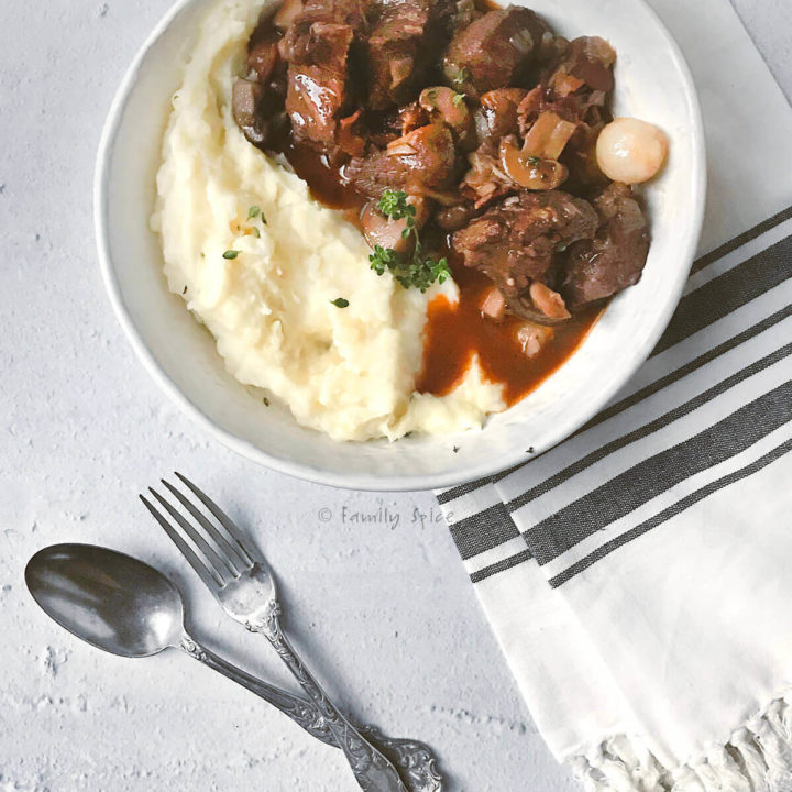 Top view of a bowl with mashed potatoes and beef bourguignon