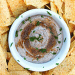 Overhead shot of black bean hummus with balsamic vinaigrette and tortilla chips by FamilySpice.com