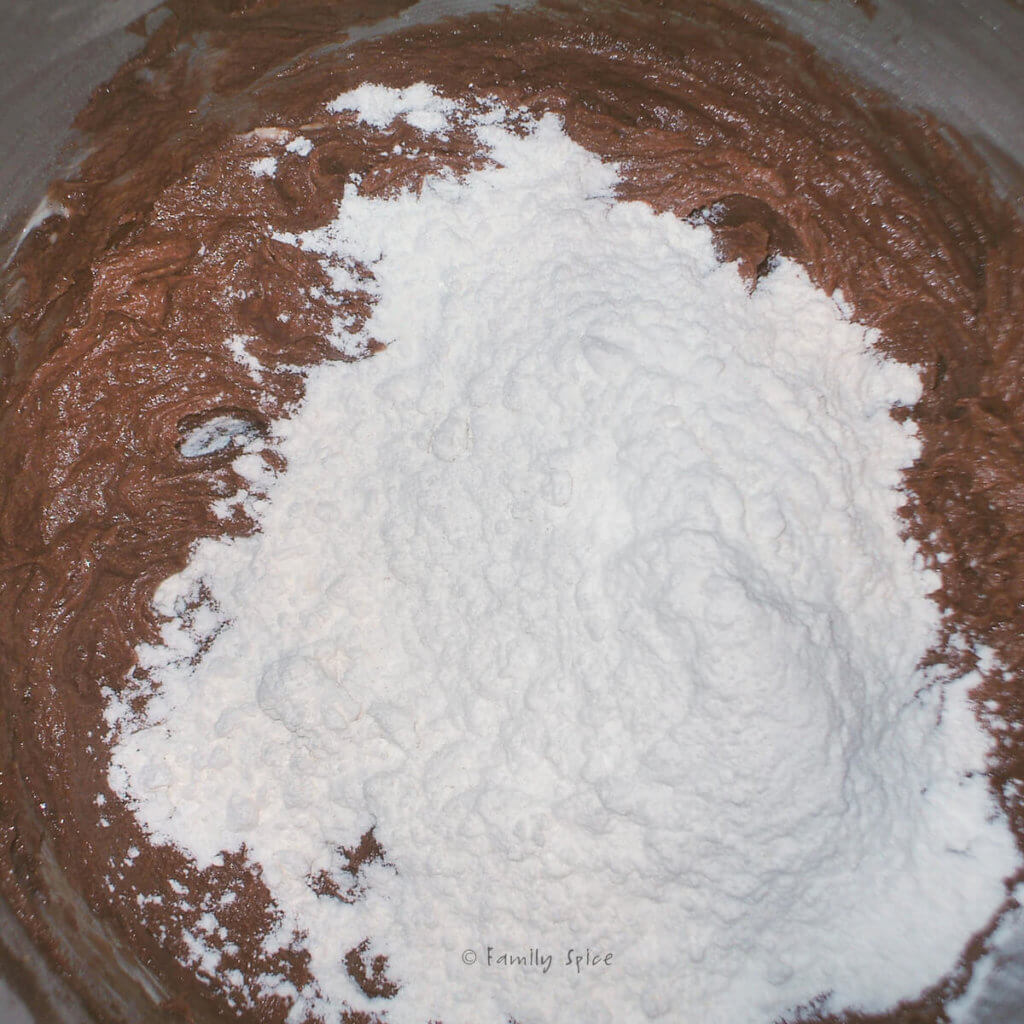 Adding flour mixture to chocolate cookie batter