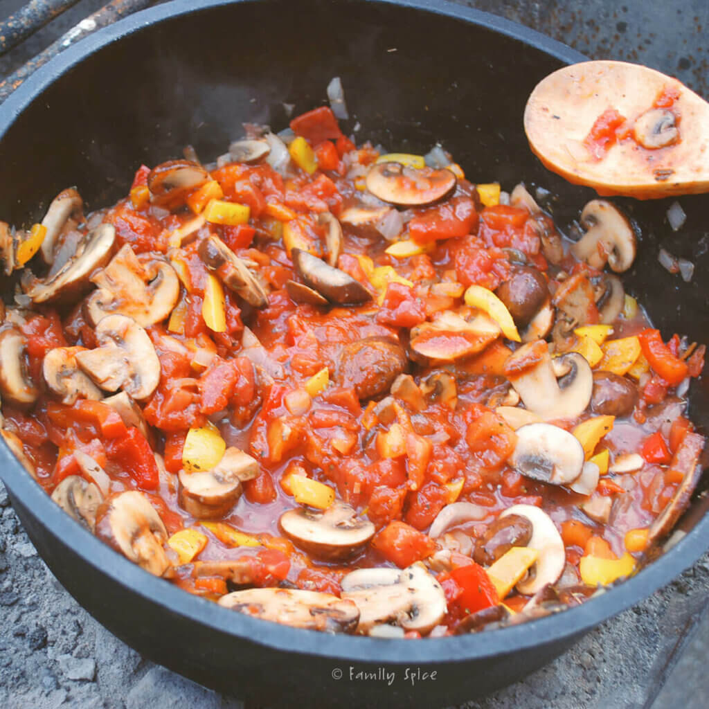 Tomatoes added to vegetables to make chicken cacciatore