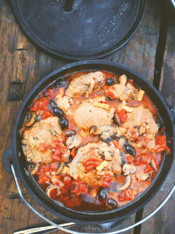 A cast iron Dutch oven with chicken Cacciatore in it