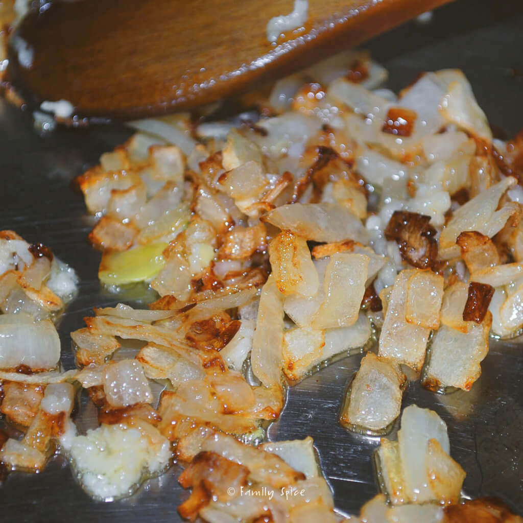 Chopped onions getting browned in a pan
