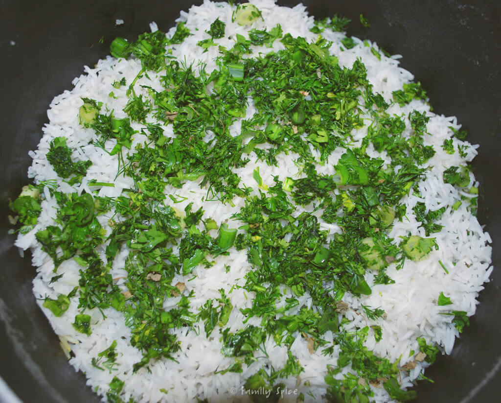 Assembling sabzi pollo (persian herb rice) in a pot