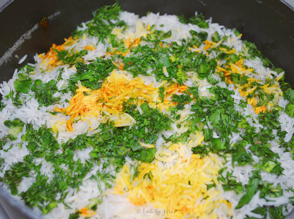 A pot with assembled sabzi pollo (persian herb rice) in it