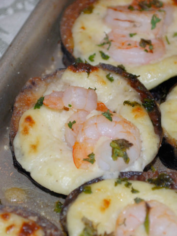A round of eggplant fried and baked with manchego cheese and shrimp