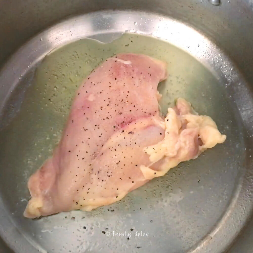 Browning chicken breast in a stainless pot