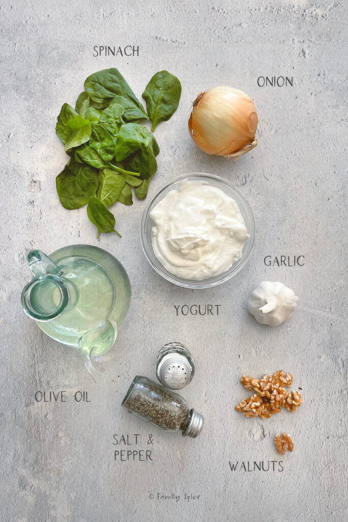 Ingredients labeled and needed to make borani esfenaj (yogurt spinach dip)