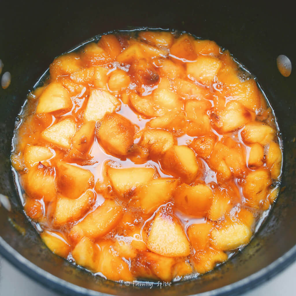 Fresh peaches macerated in a pot