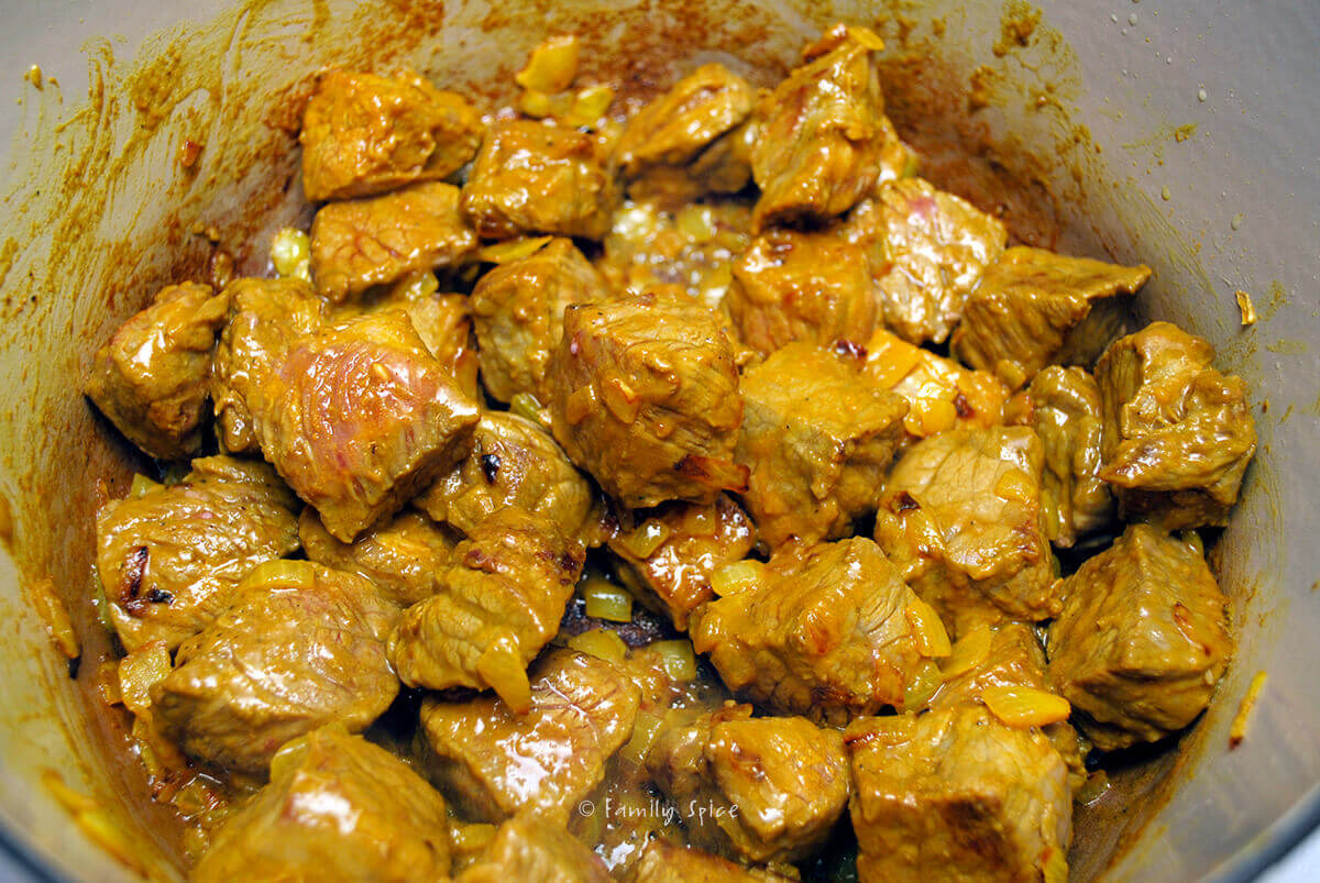 browned stew meat with turmeric seasoned sautéed chopped onions