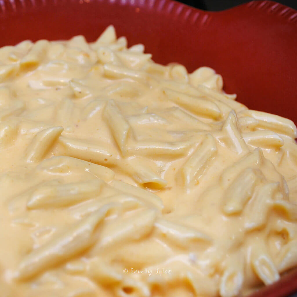 Pumpkin mac and cheese in a baking dish ready for the oven