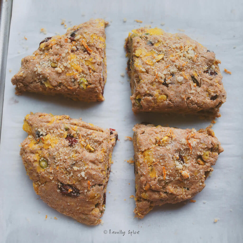 Freshly baked wholemeal pumpkin scones on a parchment paper lined baking sheet