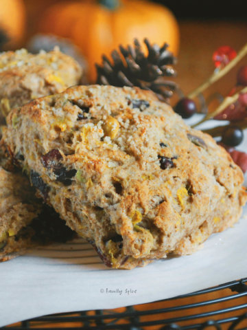 Wholemeal scones with pumpkin, cranberries and pistachios on a black wire cake stand