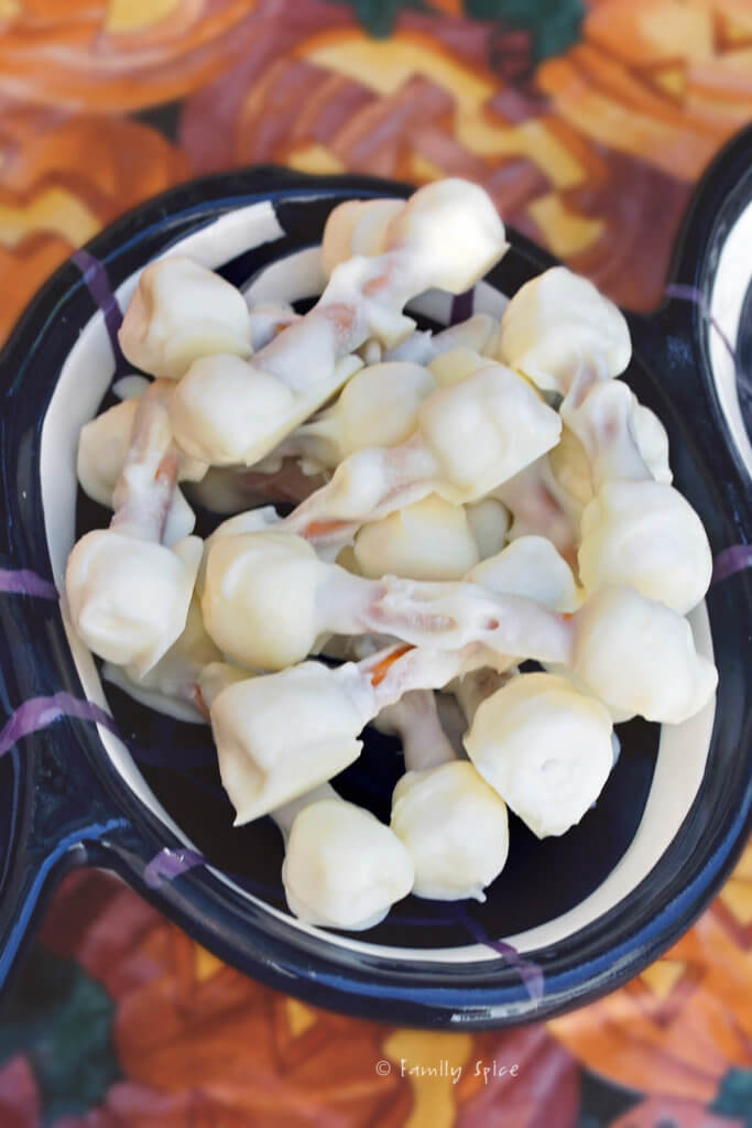 A halloween themed bowl with white chocolate covered edible skeleton bones