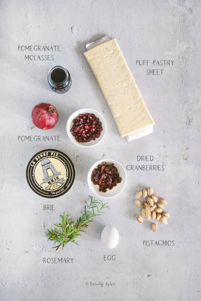 Ingredients labeled and needed to make pomegranate brie en croute (baked brie)
