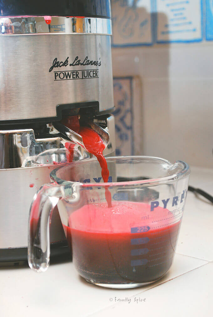 juicing pomegranate in a juicer