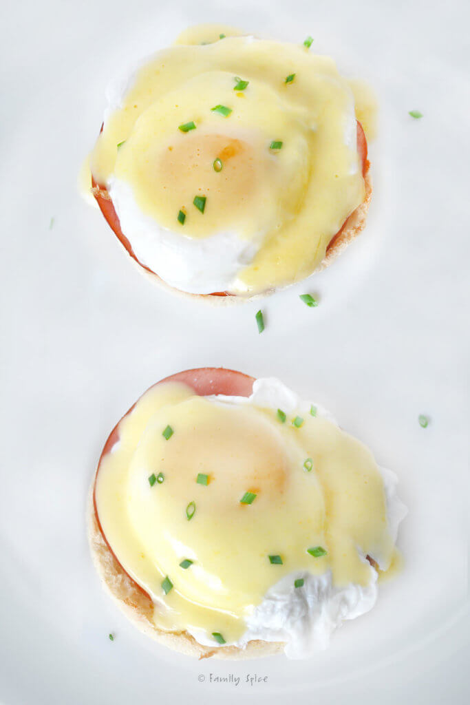 Top view of two eggs benedict with hollandaise sauce