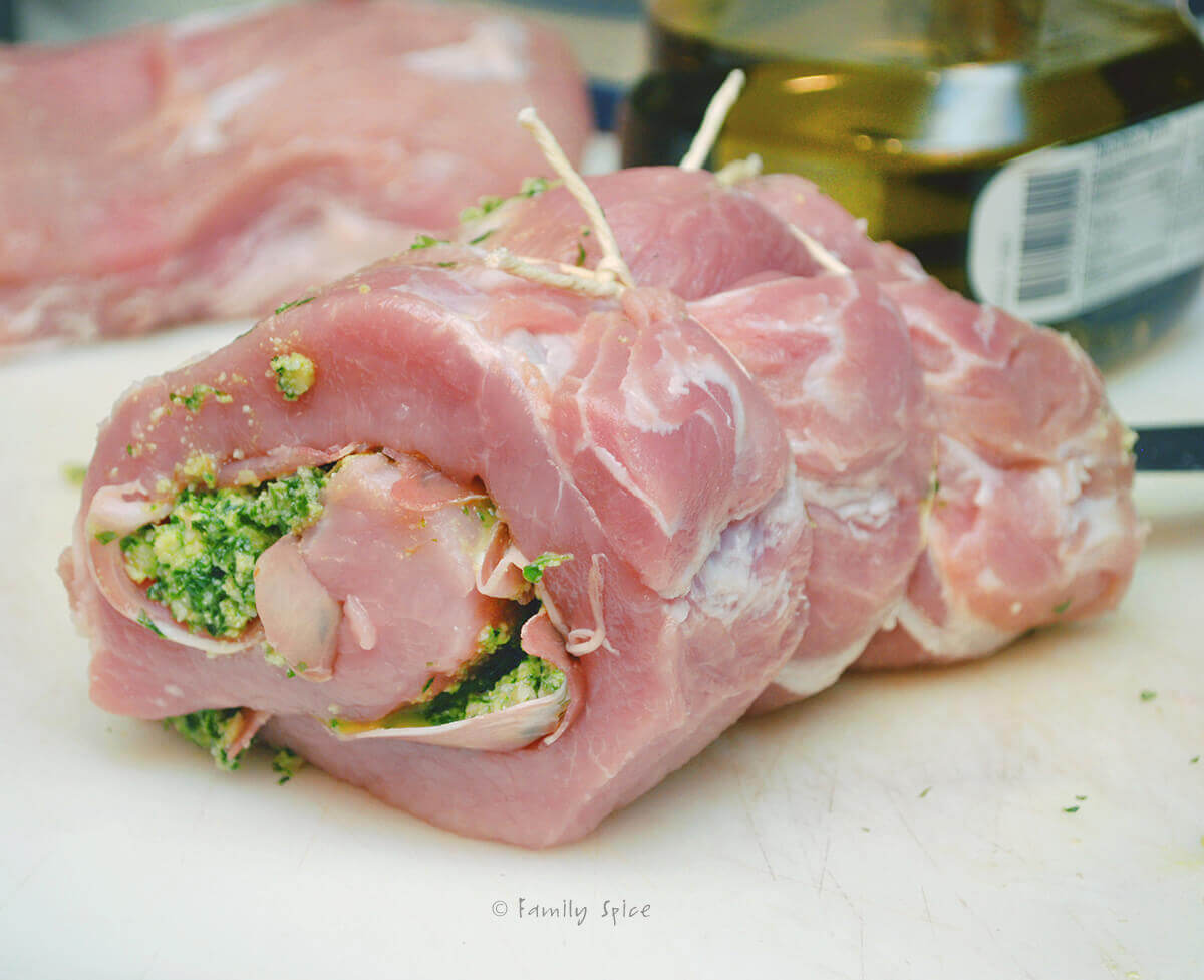 A pork loin stuffed with pesto and prosciutto rolled and tied with twine