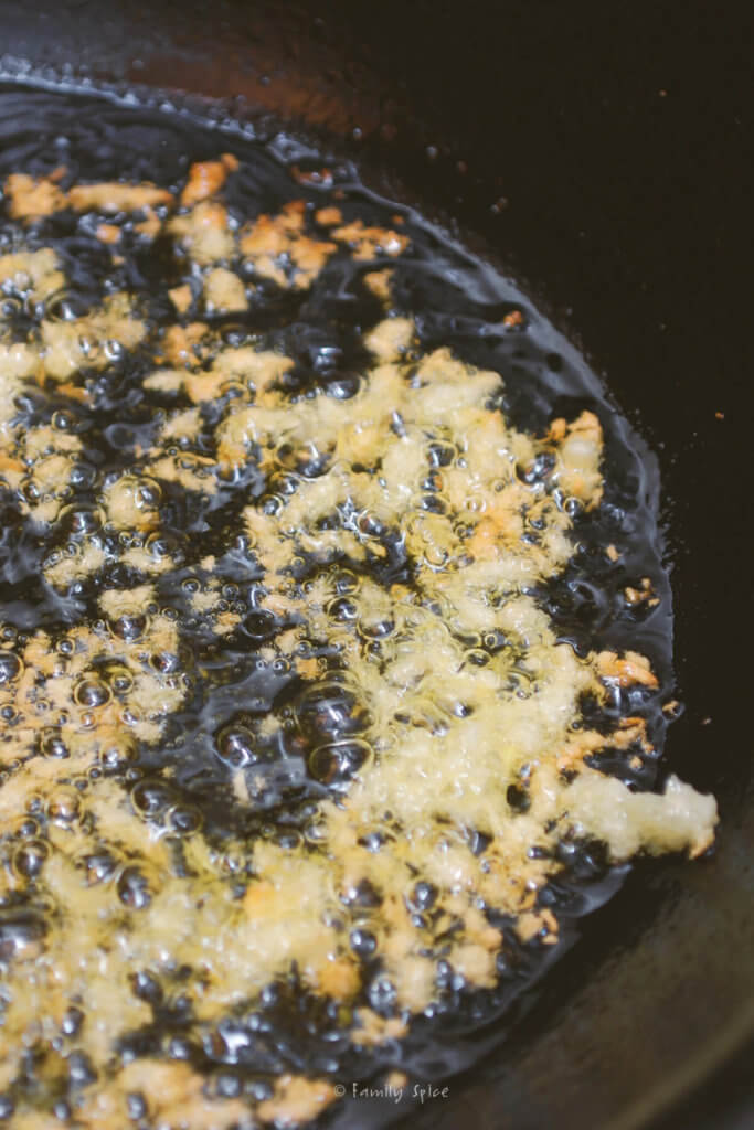 Sautéing garlic in a pan