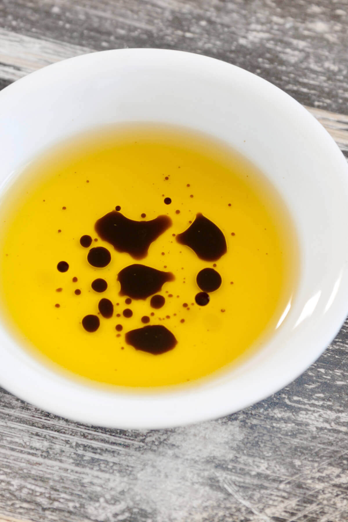 A bowl with oil and balsamic vinegar in it