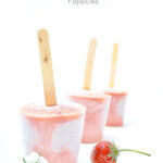 Three berry smoothie popsicles with fresh strawberry and blossom by FamilySpice.com