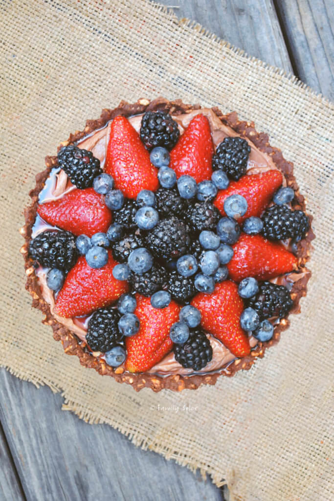 Top view of a Nutella pie with a variety of berries on top