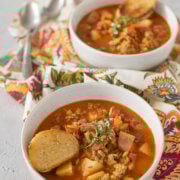 Closeup of a bowl of Manhattan clam chowder (red clam chowder) with another bowl behind it
