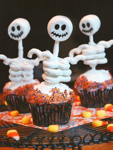 Edible skeletons on cupcakes made with marshmallow and yogurt covered pretzels