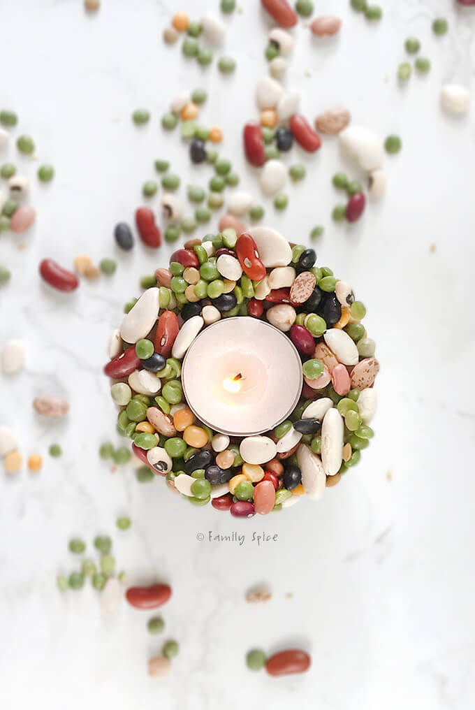 Overhead shot of a votive candle holder made with dry beans and glue by FamilySpice.com