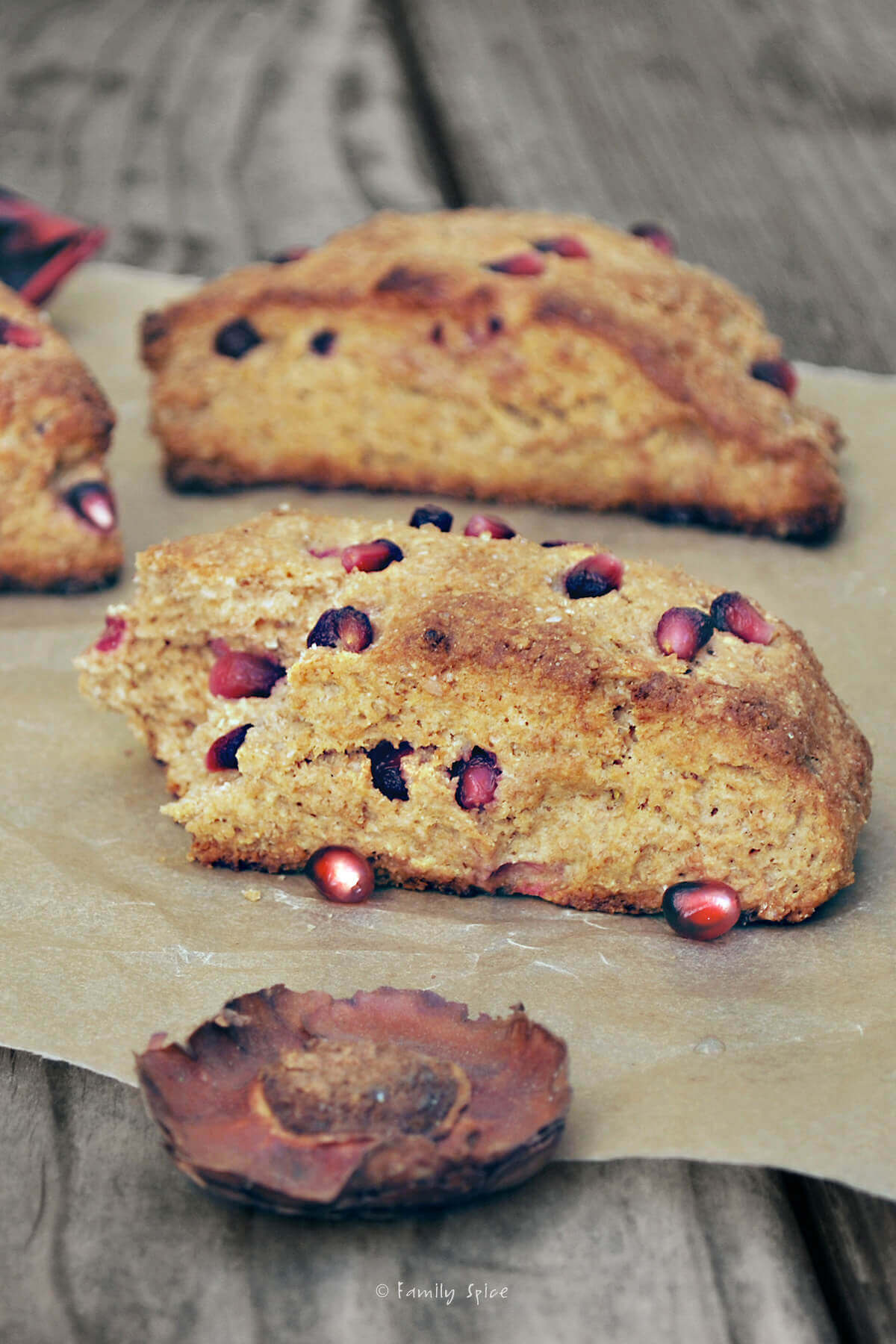 Whole wheat pomegranate scones on a wood table